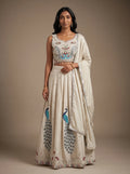 Model wearing a pearl grey georgette lehenga set with embroidered peacock motifs and matching dupatta